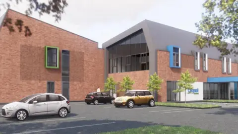 Cygnet Healthcare The building is low level and has brown brick coloured walls, with two wings in the image. There is a car park with cars in the foreground.