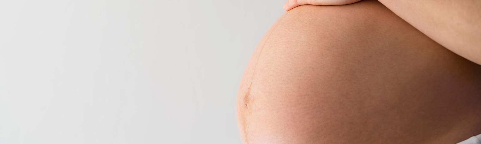 Woman holding her pregnant belly