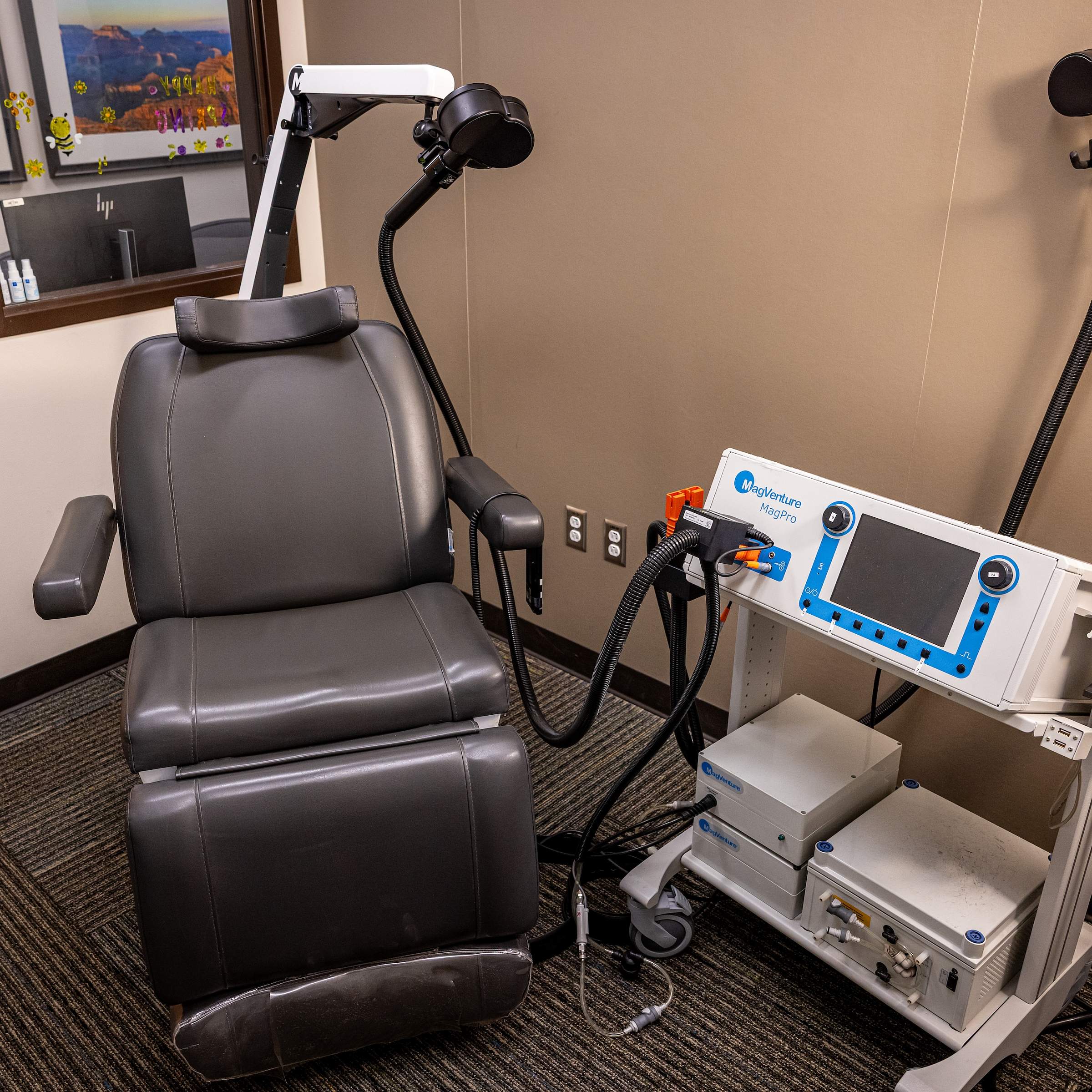 A machine that looks like a couple of white boxes attached to a chair and headpiece.